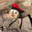 Caga Tió with blue eyes and red nose
